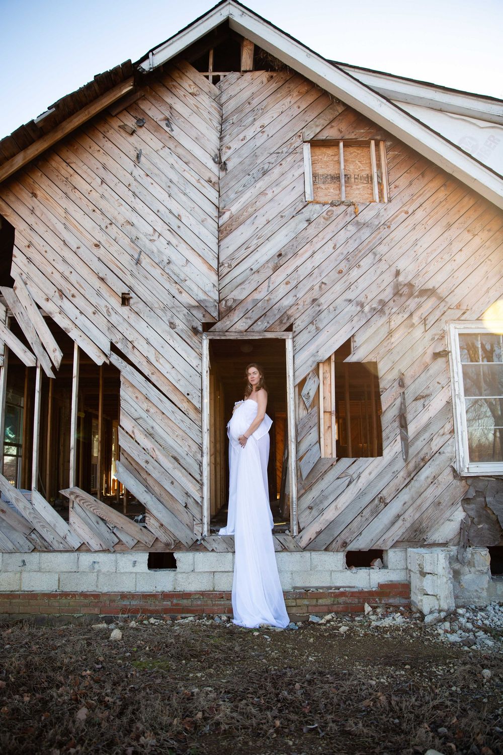 A series of photos showing a white dress against weathered wooden barn walls in different artistic compositions.