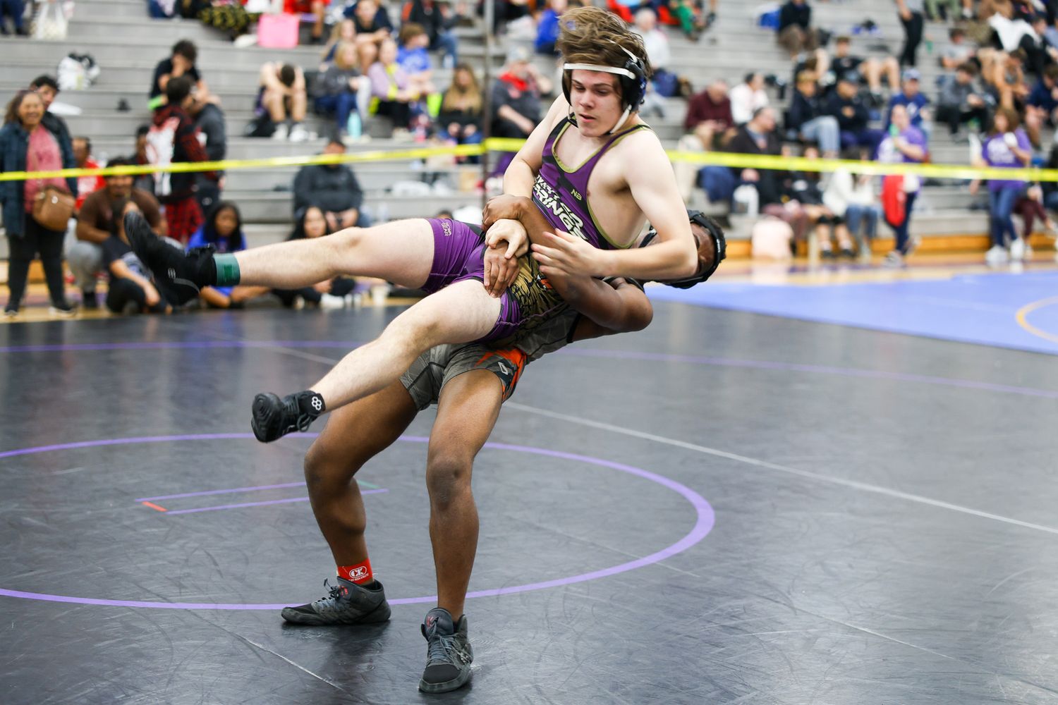 Two wrestlers compete in intense match during indoor wrestling tournament.  Oviedo, Florida