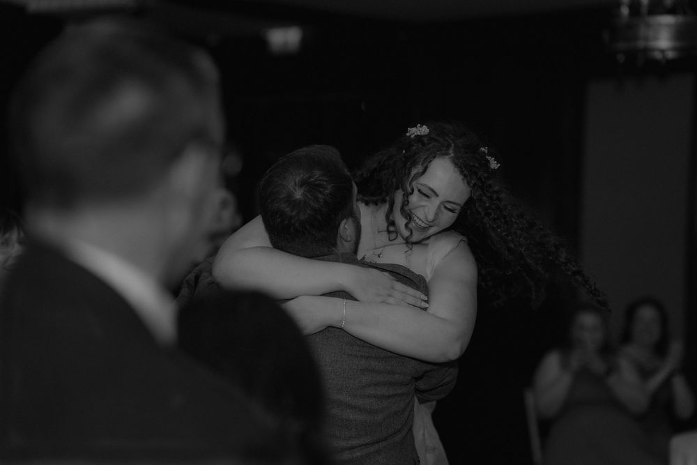 Bride and groom share an emotional first dance embrace at their wedding reception.
