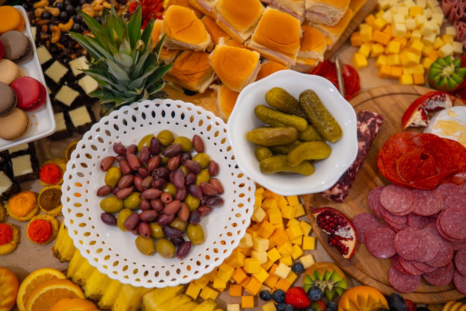Colorful charcuterie board of assorted meats, cheeses, fruits, nuts and crackers arranged on a wooden surface. Quad Cities Food Photography