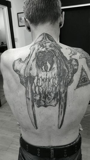 Sabre tooth tiger skull back piece with dotwork shading.