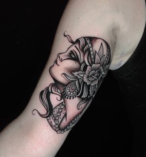 Traditional woman head. Black and grey.