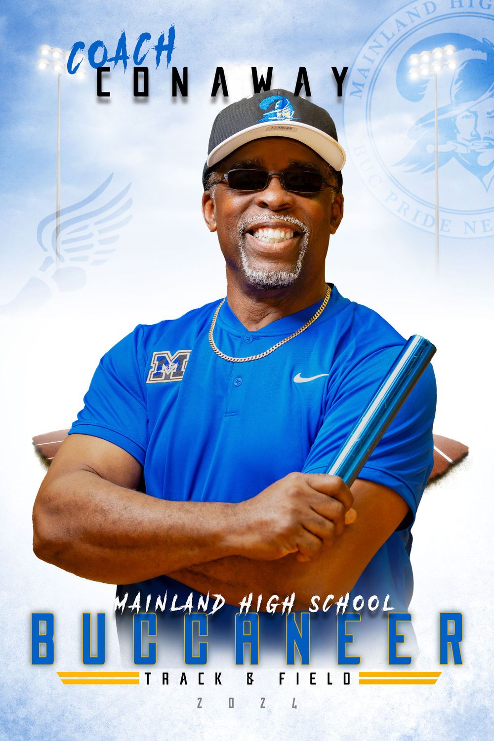 Coach wearing blue Nike polo and baseball cap smiles while holding a baton in professional sports portrait.
