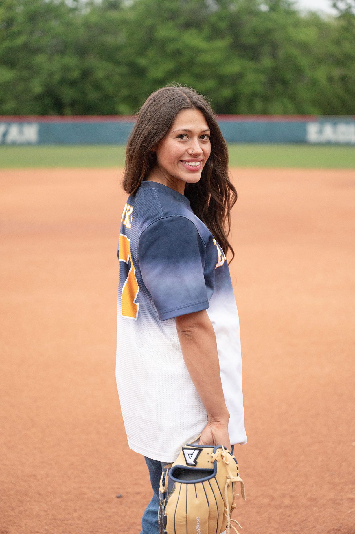 college senior girl portrait session on the OKWU softball field by Kristi Bray Photography