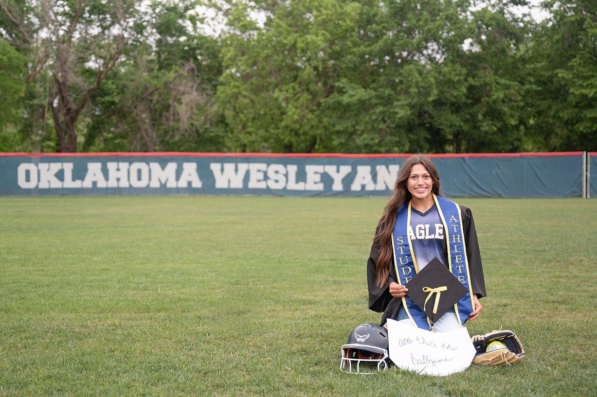 college senior girl portrait session on the OKWU softball field by Kristi Bray Photography