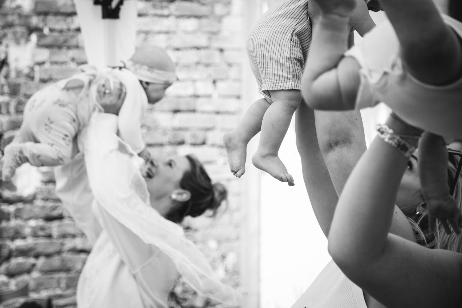 Black and white photo capturing joyful movement and interaction during an outdoor exercise session.