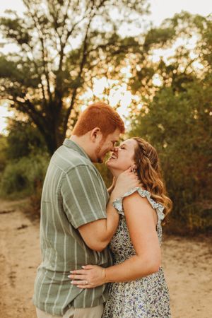 Romantic sunset photoshoot in a natural outdoor setting.