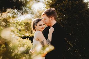 Romantic sunset wedding photos with couple embracing in golden light.
