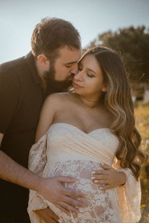 Intimate couple's portrait in golden light with romantic embrace.