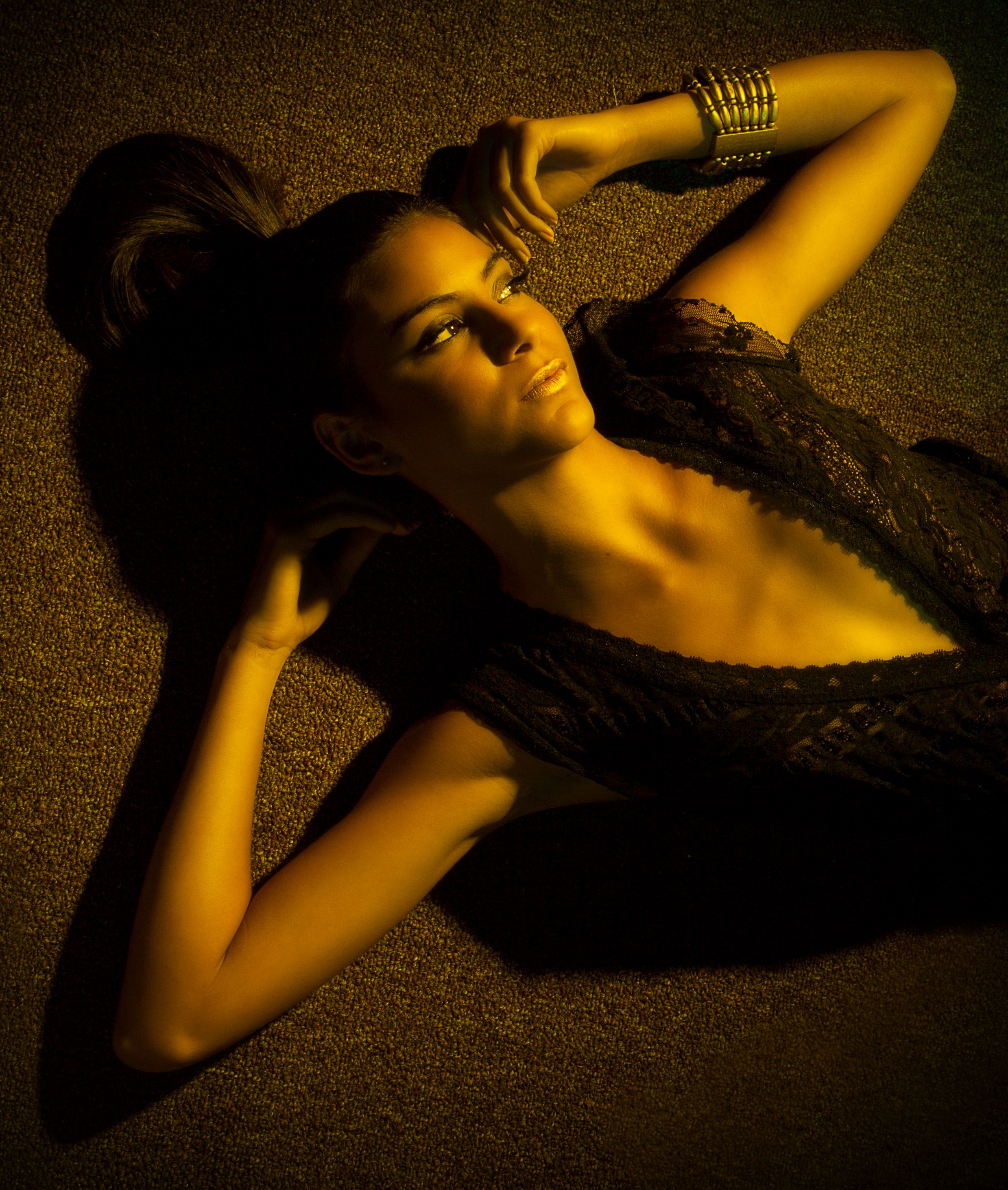Artistic portrait with golden lighting and dramatic shadows.