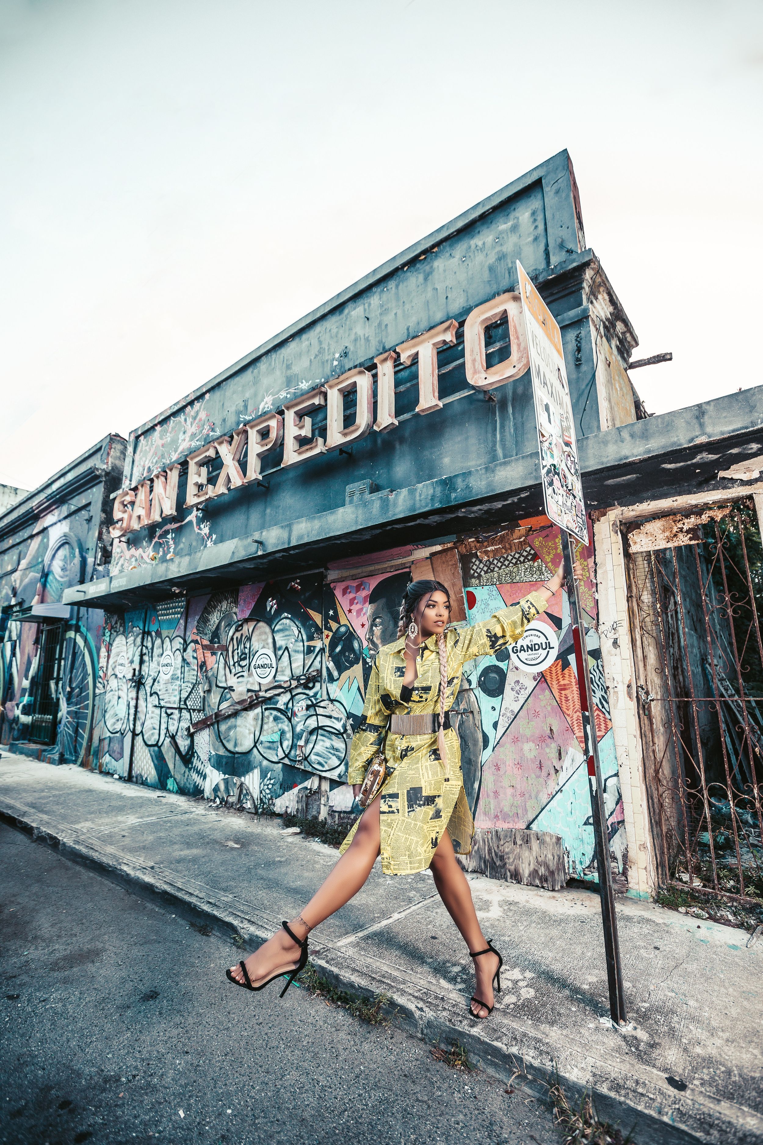 Street fashion photo in front of urban graffiti wall with Expedito signage.
