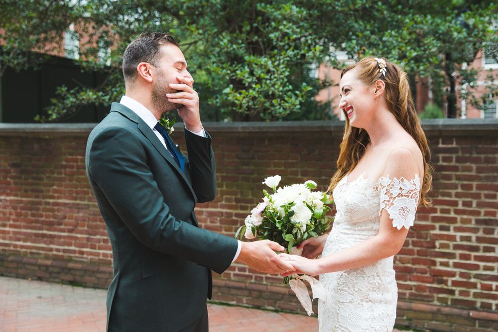 Romantic wedding ceremony moments captured against a brick wall backdrop.