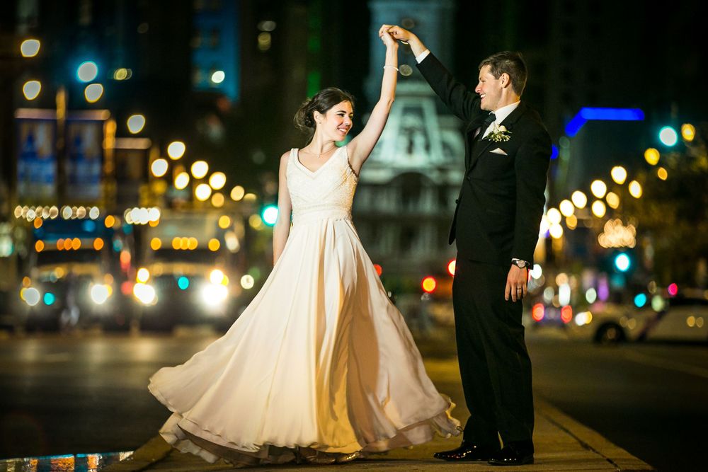 Romantic nighttime wedding photos with city lights and bokeh creating a dreamy urban atmosphere.