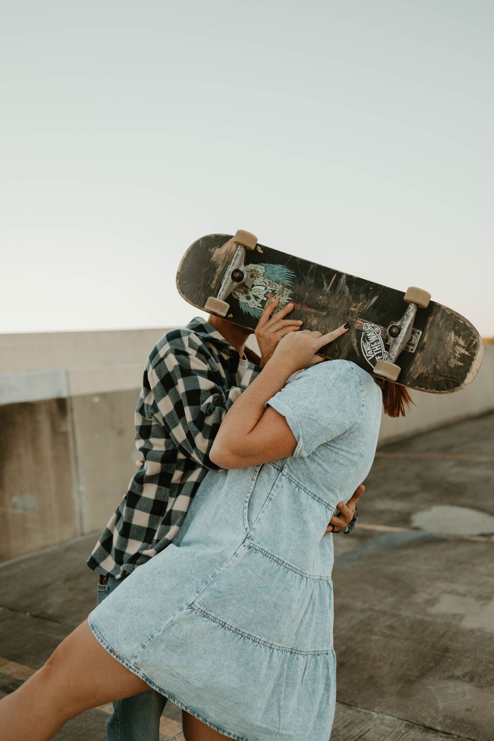 Artistic sequence showing a skateboard being carried in various positions against sunset lighting.