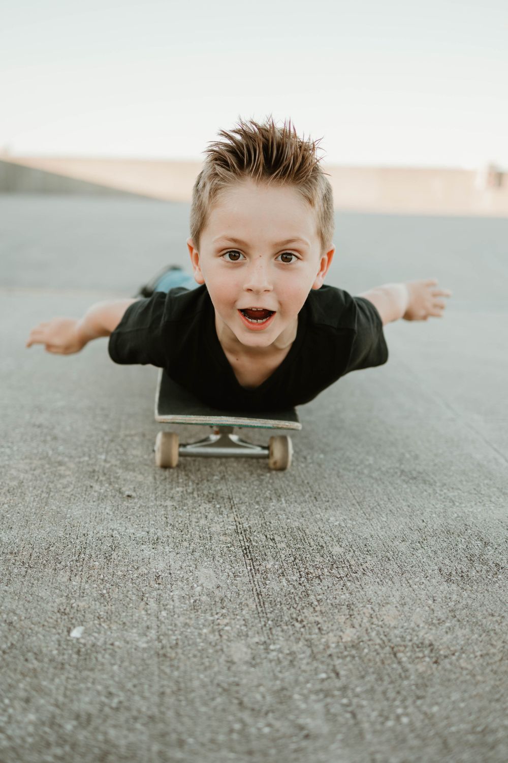 Dynamic skateboarding sequence showing a horizontal balancing trick on concrete.