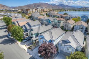 Aerial view of a lakeside residential neighborhood with multi-story homes and mountain backdrop in Reno, Nevada.