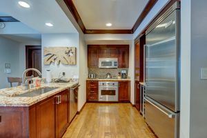 Upscale kitchen with cherry wood cabinets, granite counters, and stainless steel appliances.