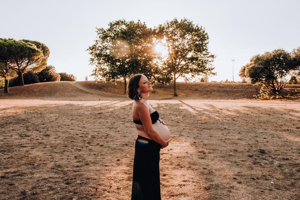 A side profile silhouette against a golden sunset with trees in the background.