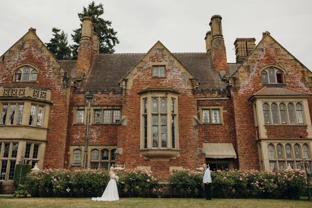 Stunning Victorian brick mansion with tall chimneys and ornate architecture serves as backdrop for wedding celebrations.