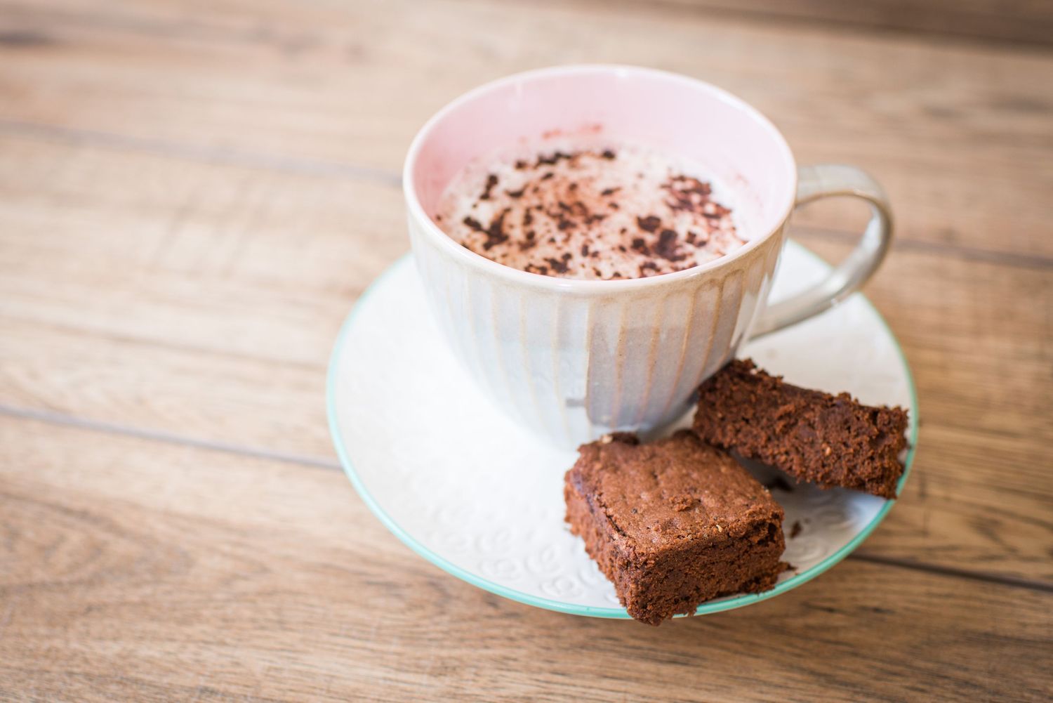Cup of cappuccino with a chocolate brownie on the side