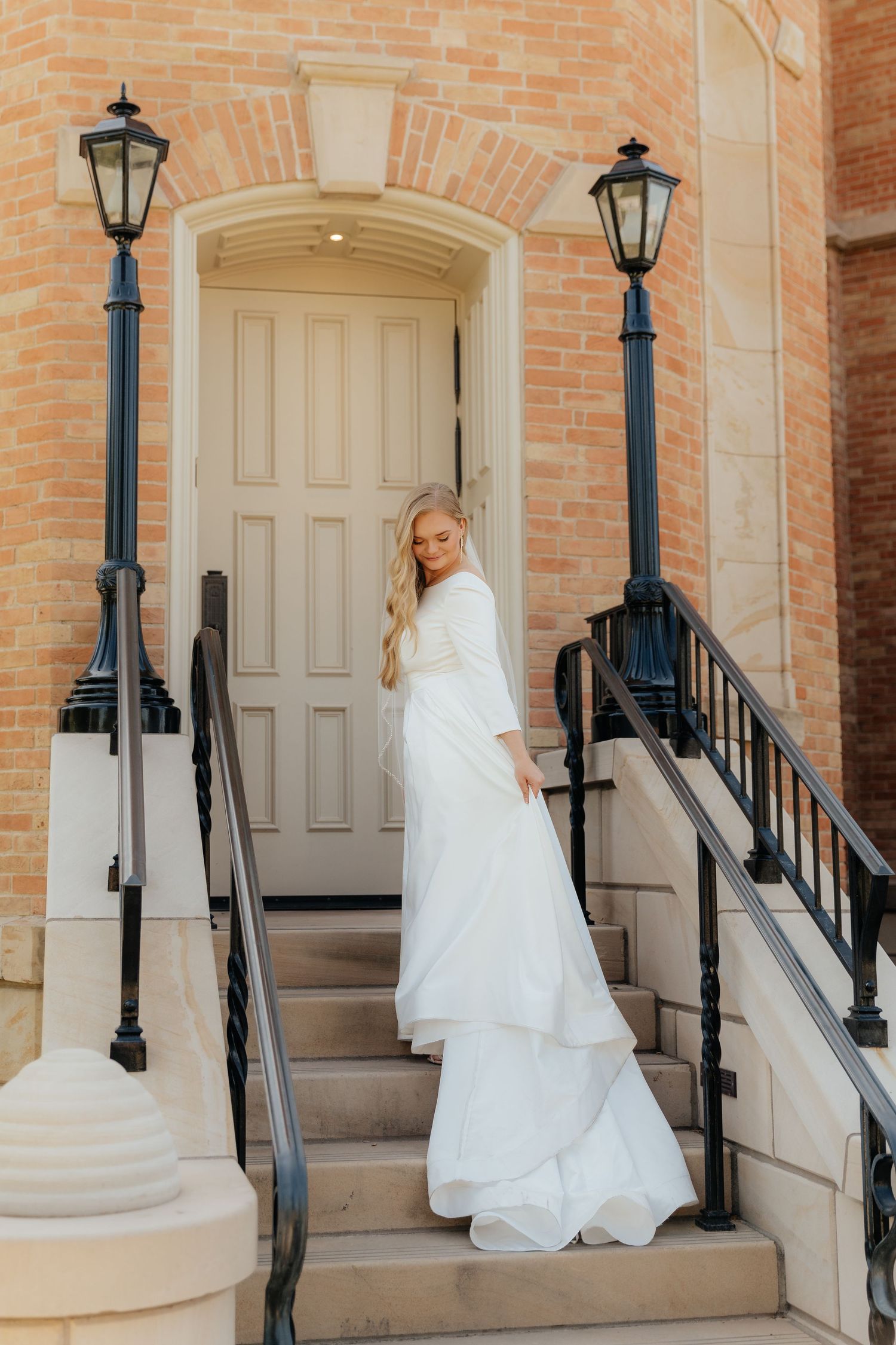 Bride standing on steps at Provo City Center LDS Temple, swaying dress