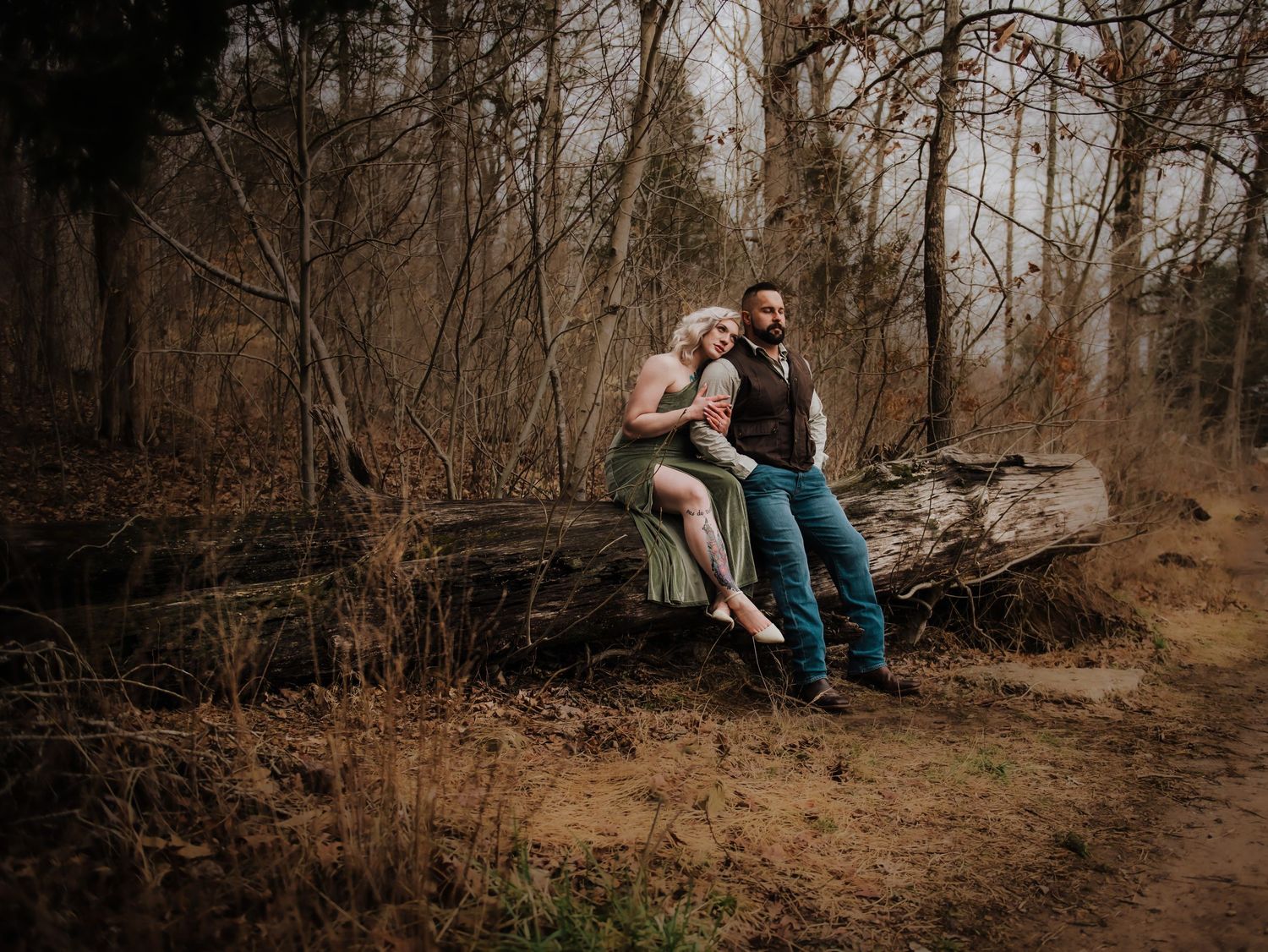 A series of romantic outdoor engagement photos captured in a wooded natural setting during autumn.