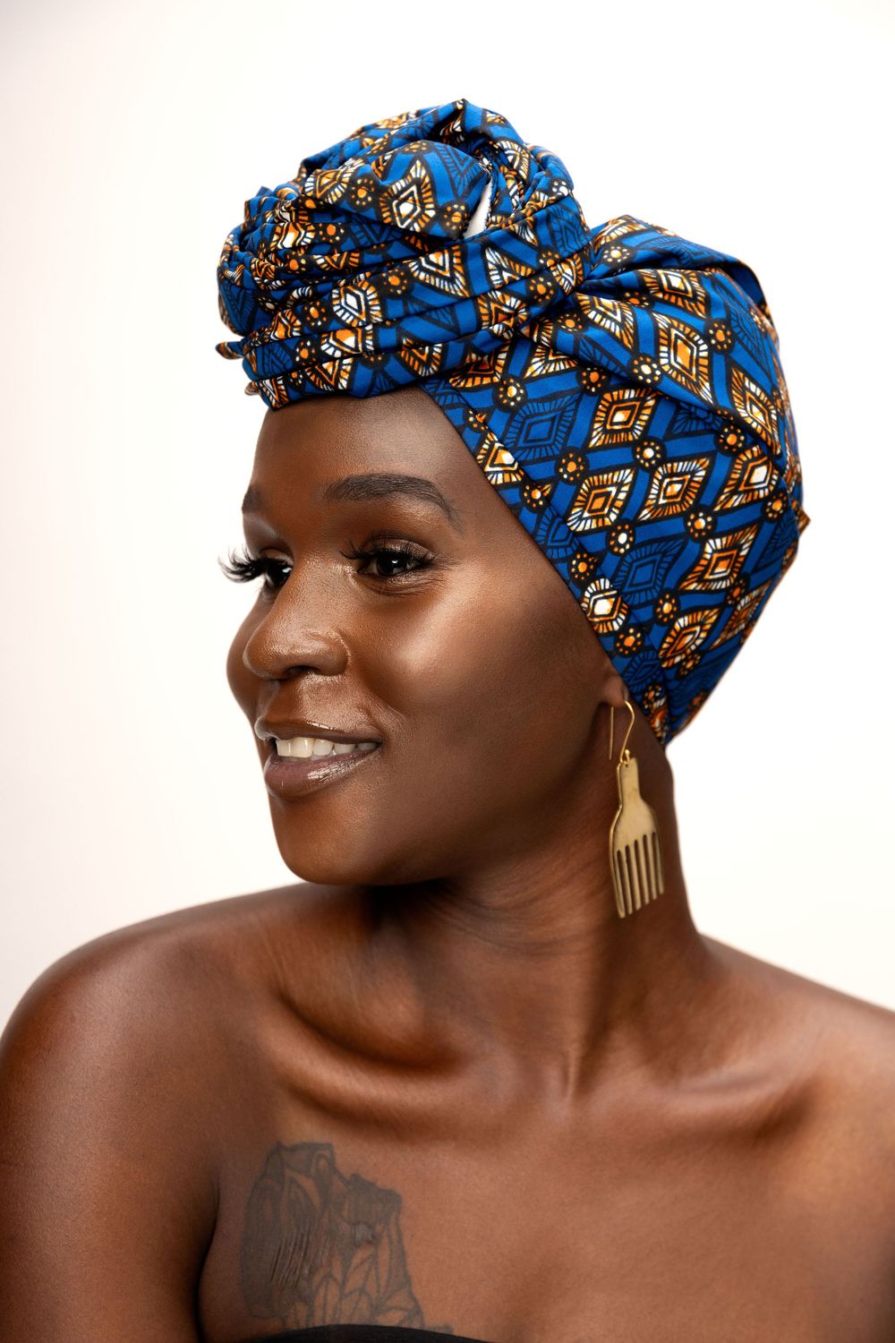 Portrait series featuring blue and gold patterned headwrap and gold earrings against white backdrop.