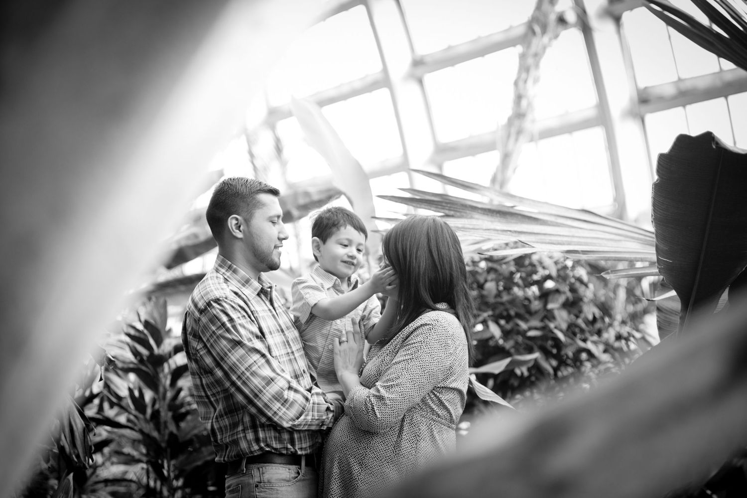 A series of candid black and white family moments showing affection and connection.