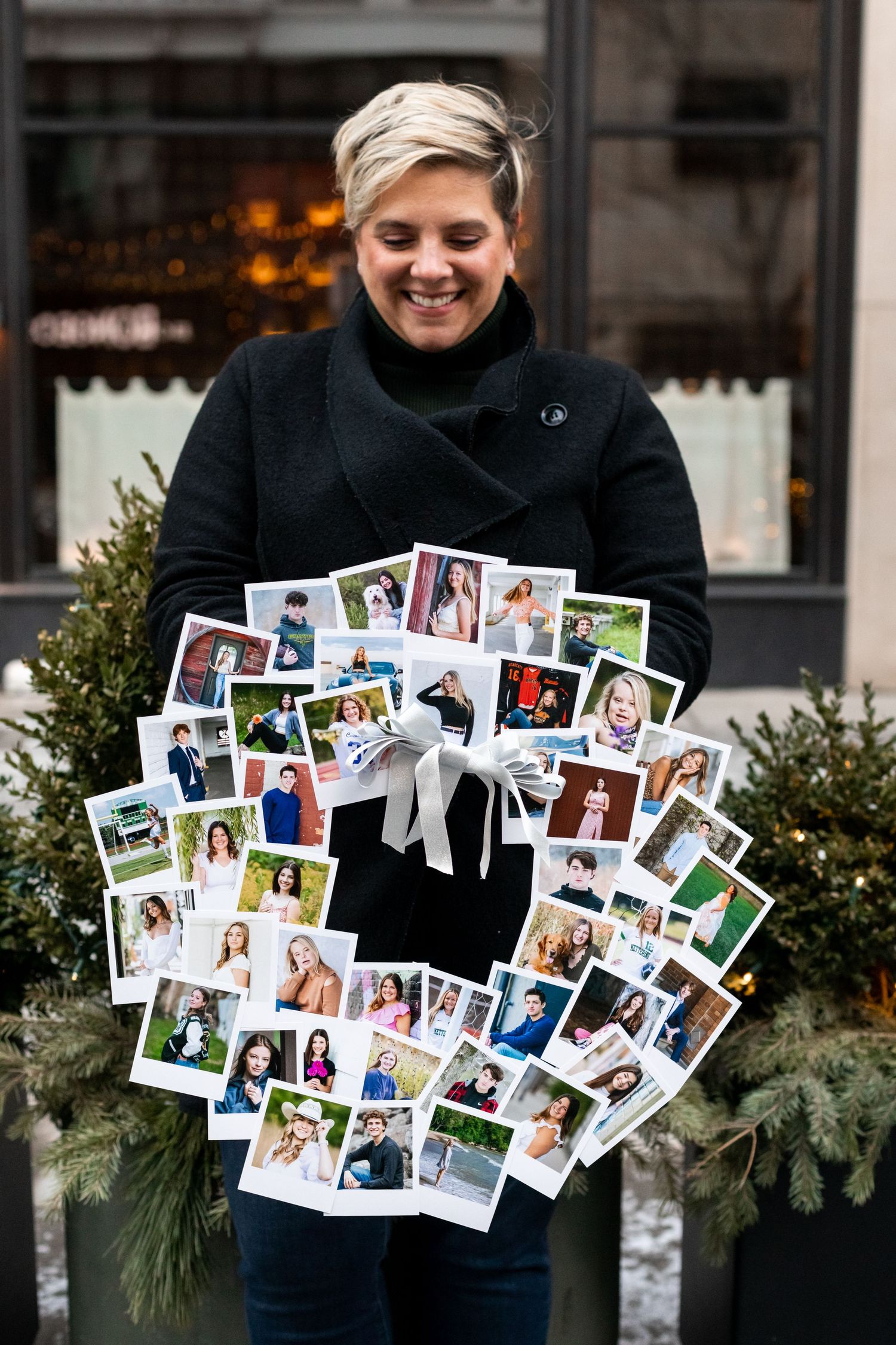 Aly Darin holding printed products of senior photography clients, beverly hills, mi