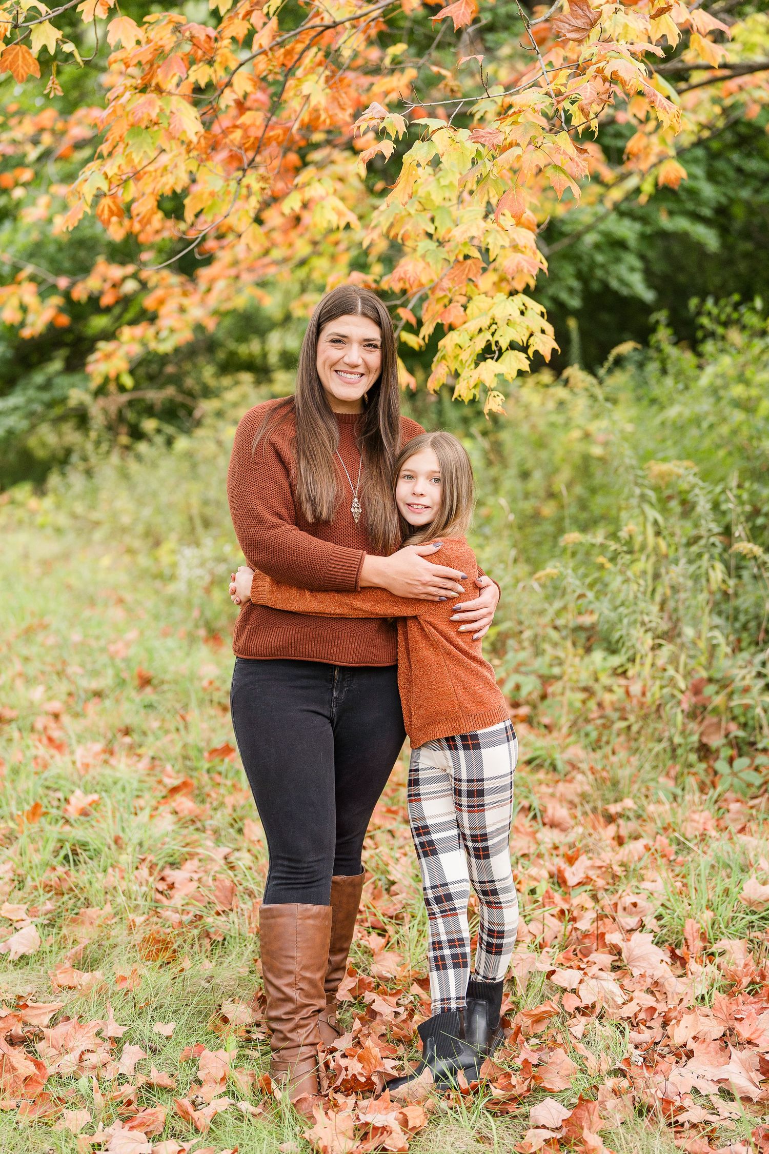 aunt and niece photoshoot at busse woods. standing in a field posing taken by a milwaukee wedding photographer