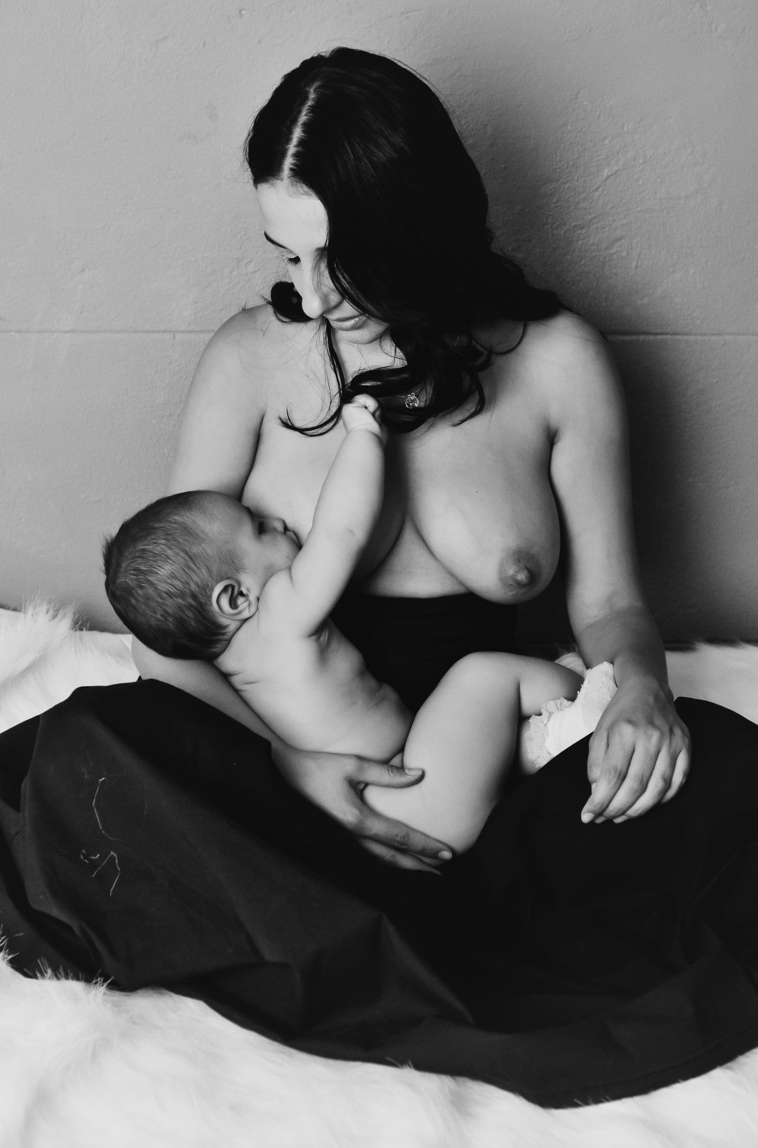 beautiful mom breastfeeding baby in photo studio, Johannesburg