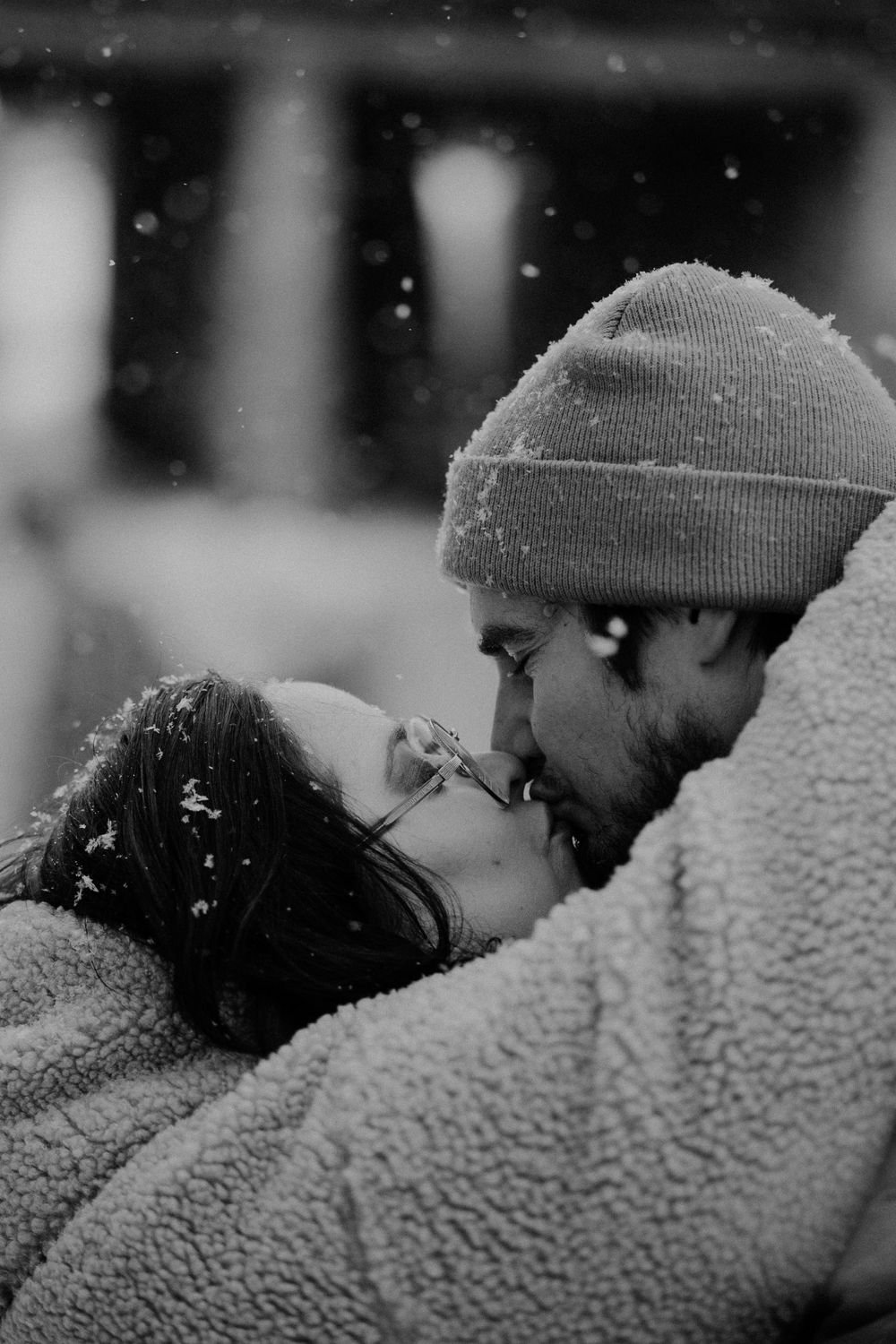 A romantic winter scene with snowflakes falling in black and white.