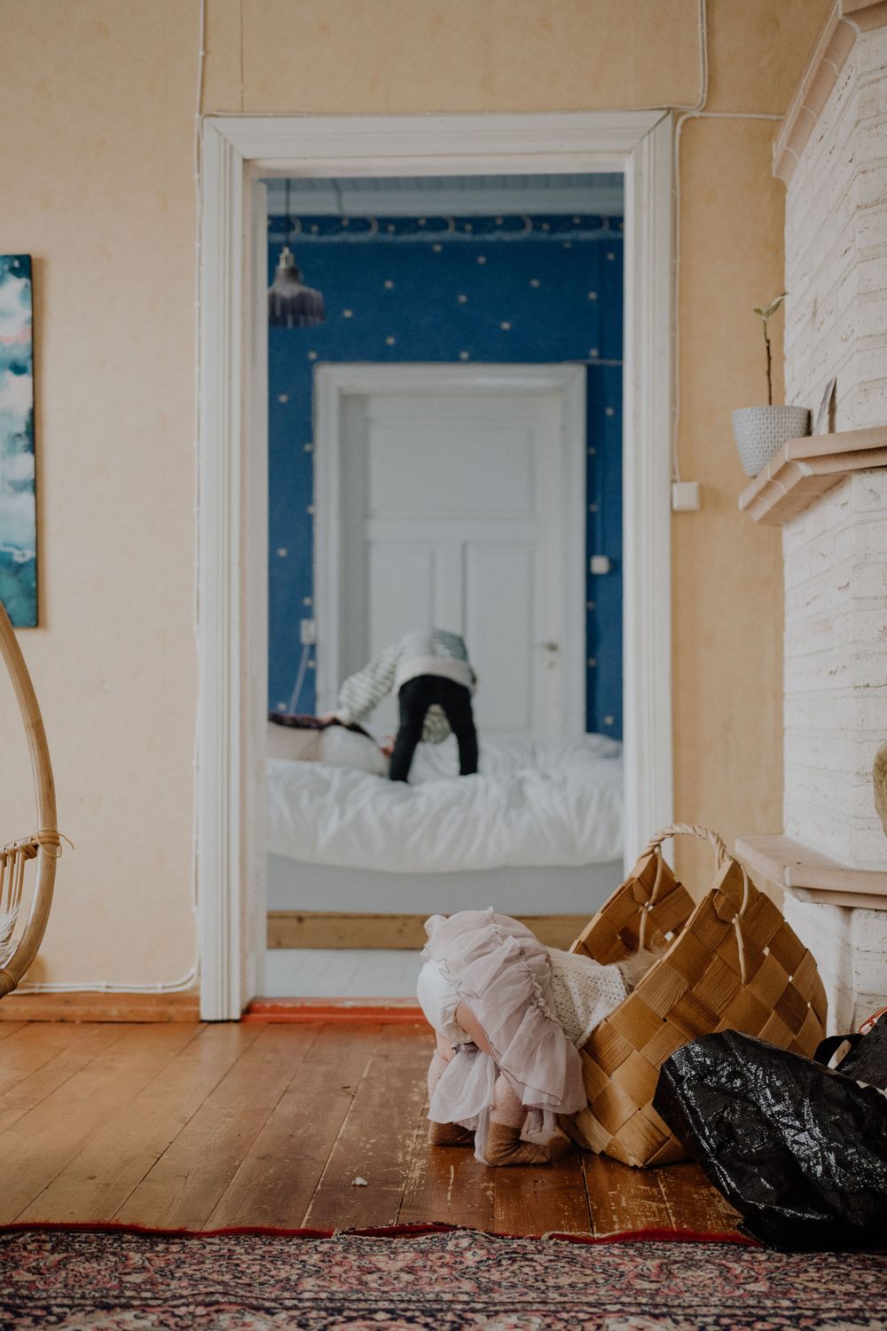 Playful indoor scene with stuffed toys and decorative doorway with star pattern.