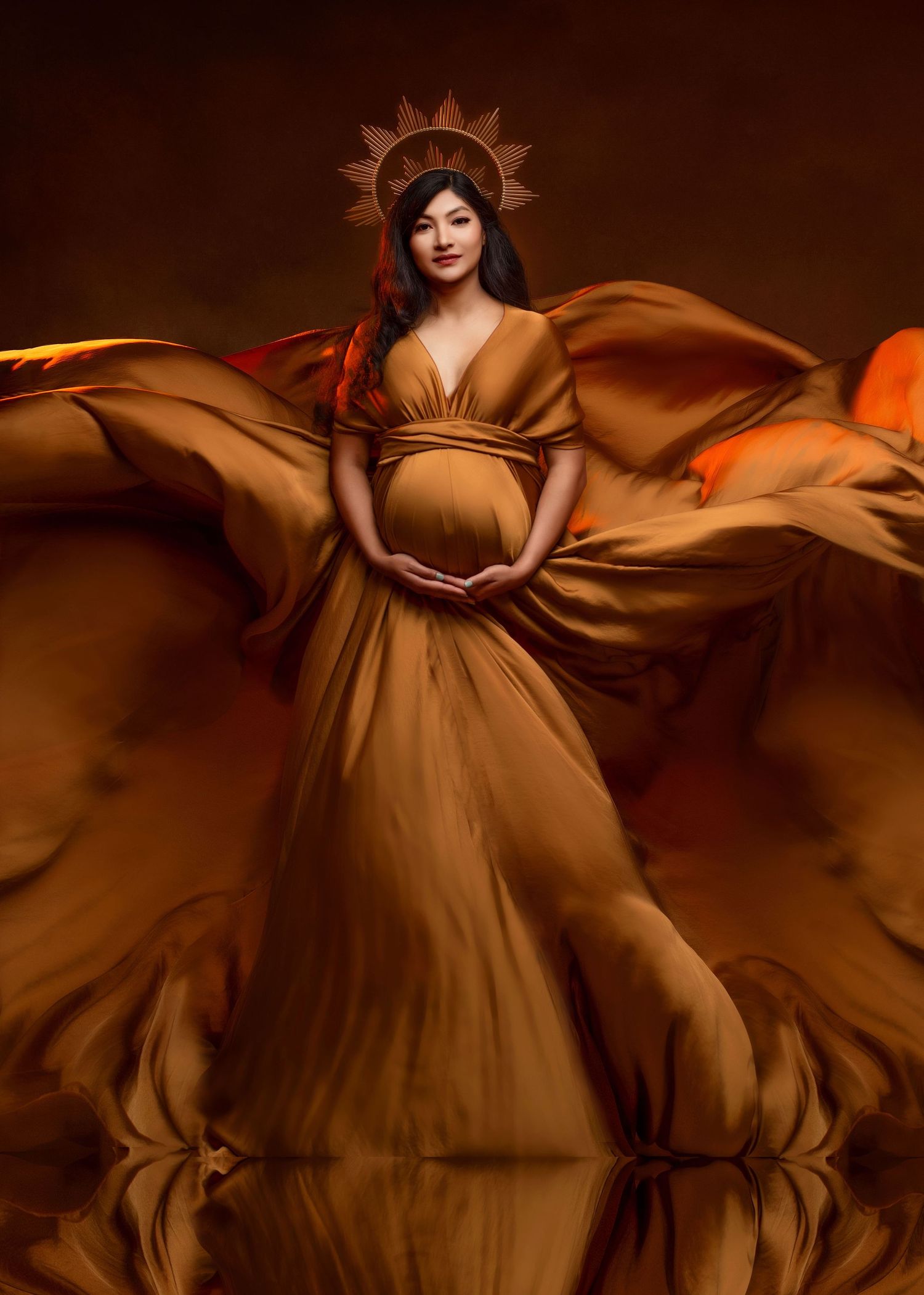 goddess style maternity photos in this portrait with an expecting mother wearing a flowing dress and golden headpiece