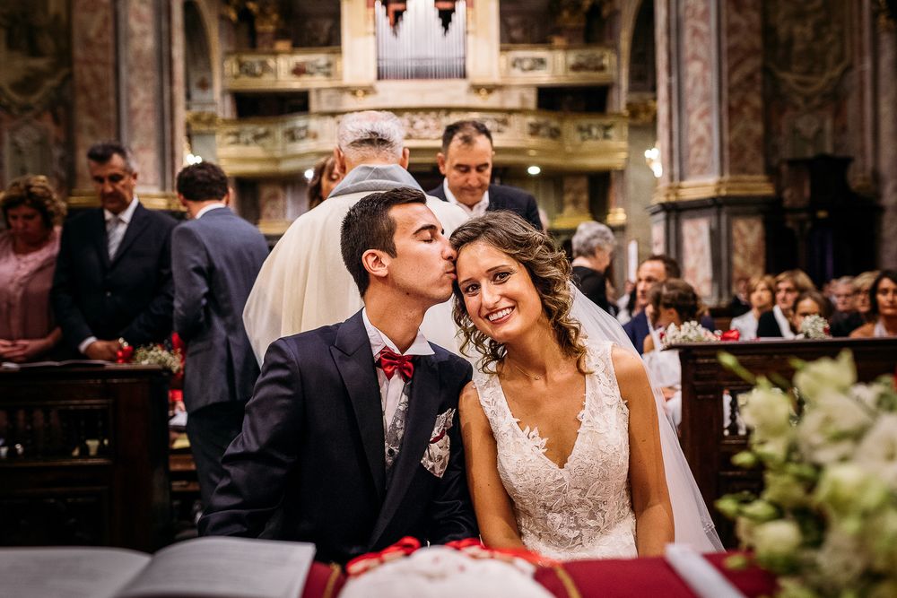 Intimate moment shared during traditional church wedding ceremony.