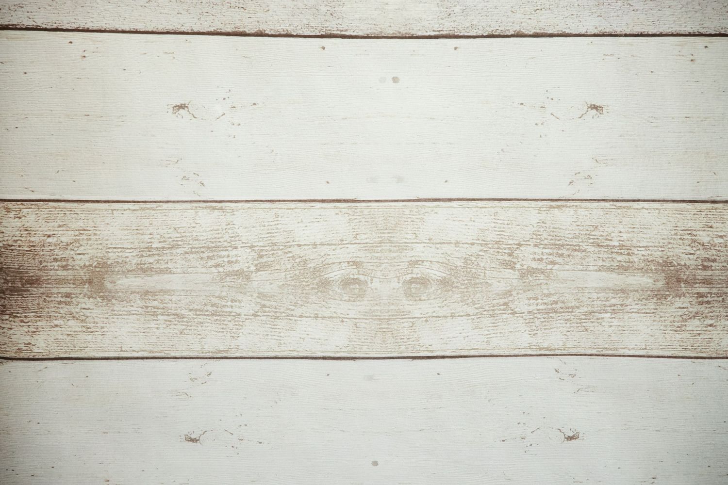 Weathered white wooden planks with rustic texture and natural grain patterns.