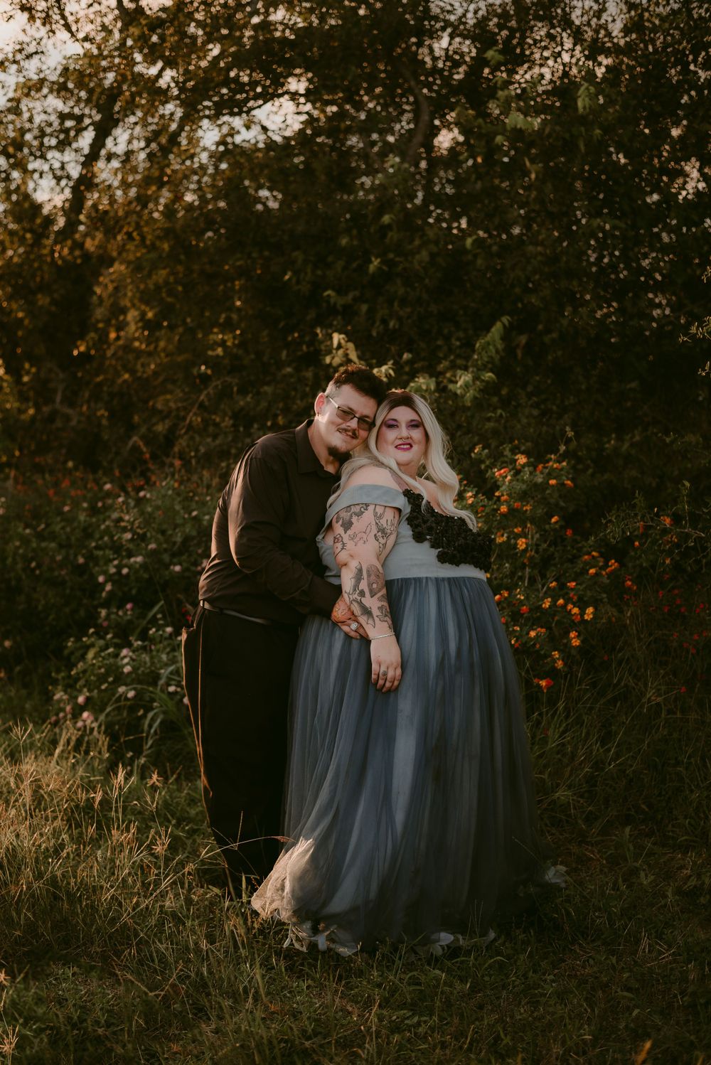 Intimate couples portrait during golden hour in a natural setting.