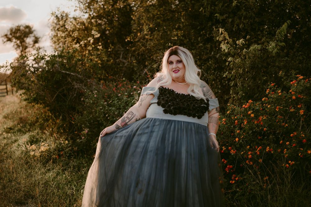 Sunset portrait session with wildflowers and a flowing blue dress.