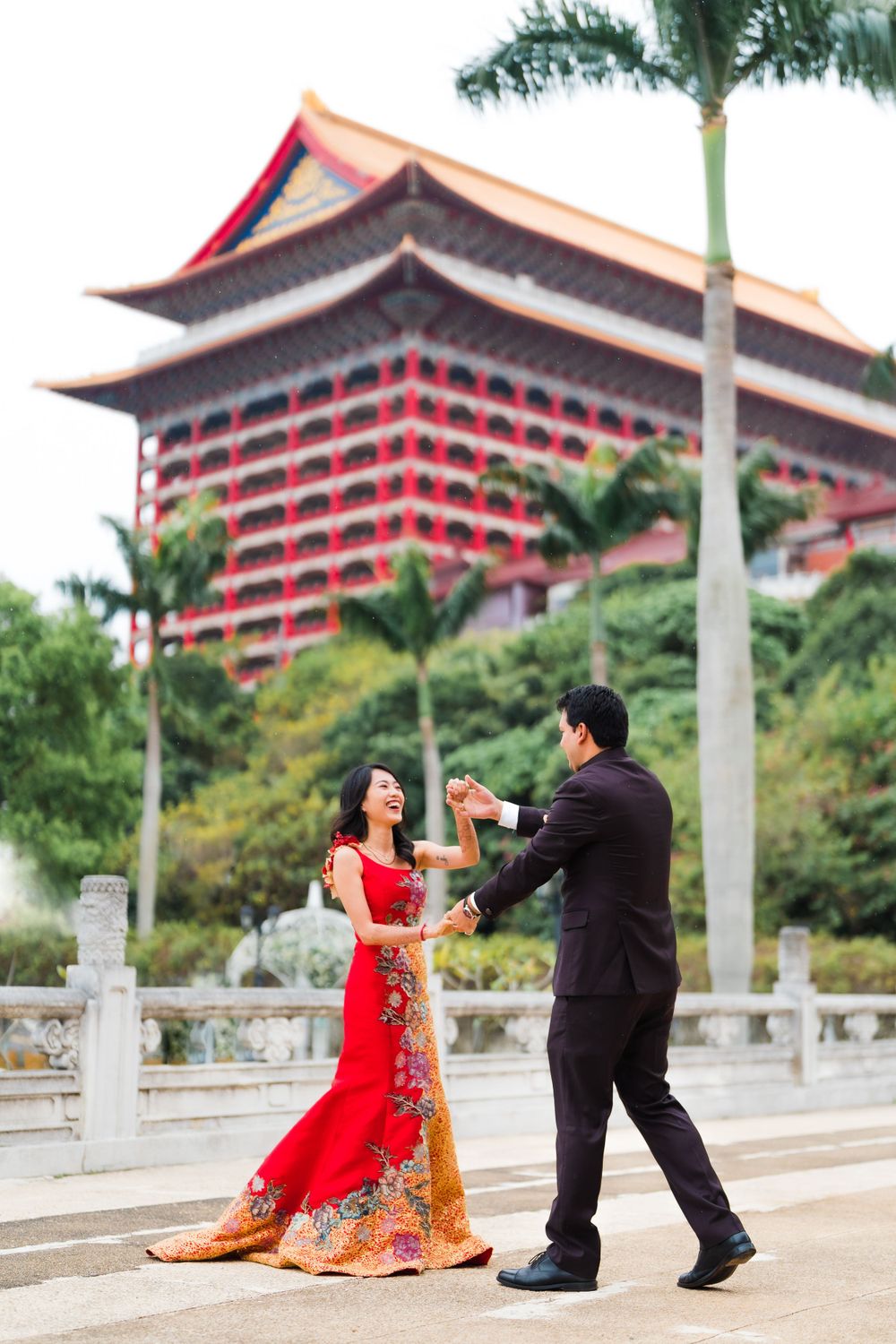 Couple dancing together in front of the iconic Grand Hotel in Taipei.