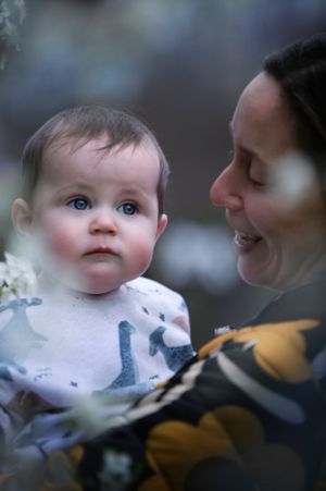 A tender moment shared between parent and baby in soft lighting with a dreamy bokeh effect in the background.