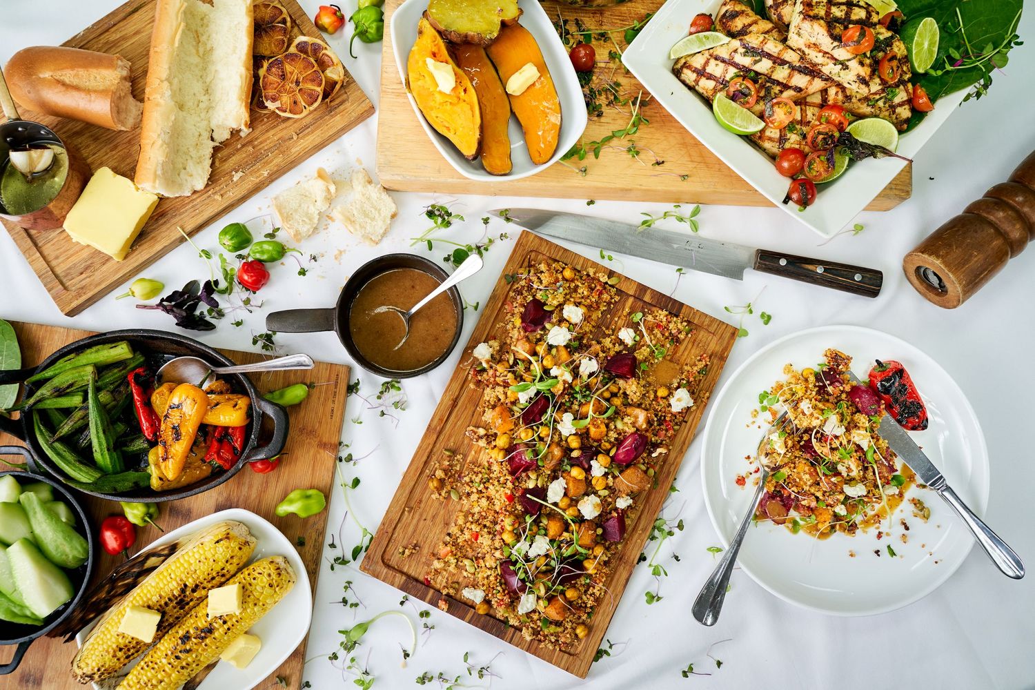 Overhead view of colorful brunch dishes and drinks spread across a table setting.