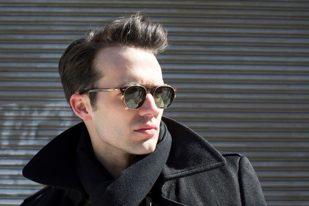Stylish winter portrait against metal shutter background with dramatic lighting.
