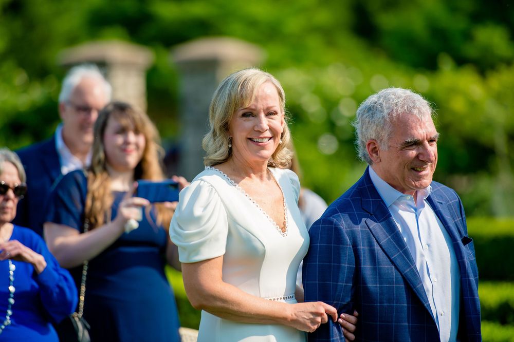 Wedding guests gather outdoors on a sunny summer day.Commodore Perry Estate Wedding