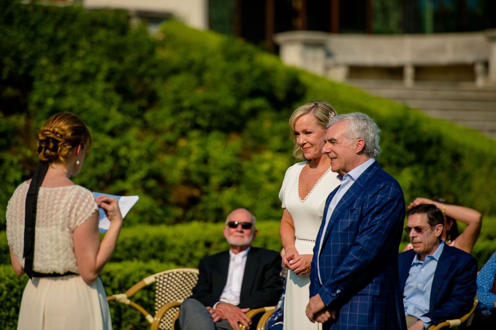 Outdoor wedding ceremony taking place in a beautiful garden setting.Commodore Perry Estate Wedding