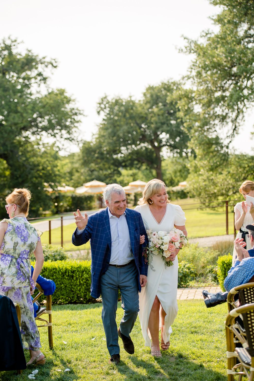 Celebratory exit down garden path after wedding ceremony.Commodore Perry Estate Wedding