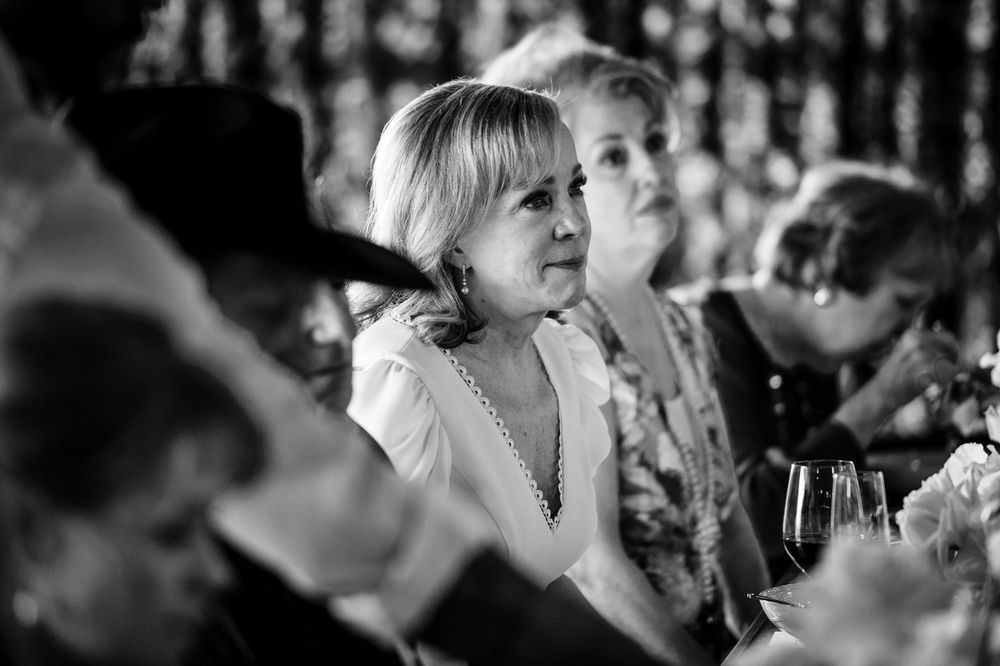 An elegant black and white candid moment captured during a wedding reception.Commodore Perry Estate Wedding