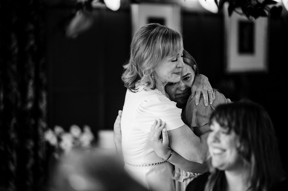 A touching moment of laughter and joy captured during a celebration.Commodore Perry Estate Wedding