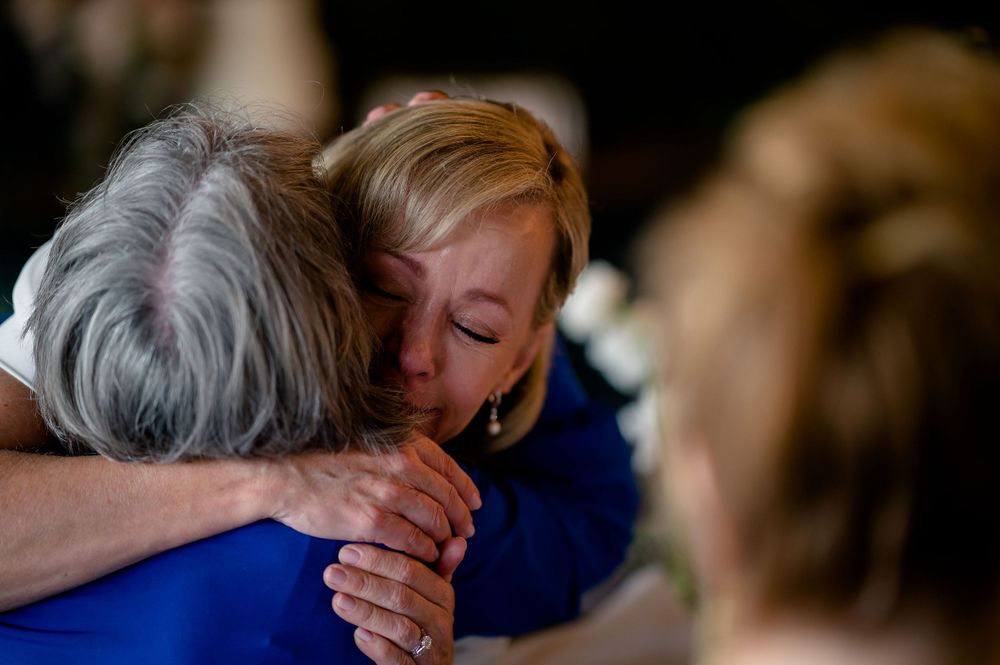 An emotional embrace shared during a special moment at a celebration.Commodore Perry Estate Wedding
