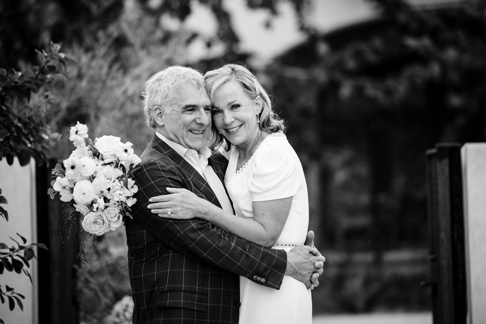 A black and white portrait of a couple embracing outdoors.Commodore Perry Estate Wedding