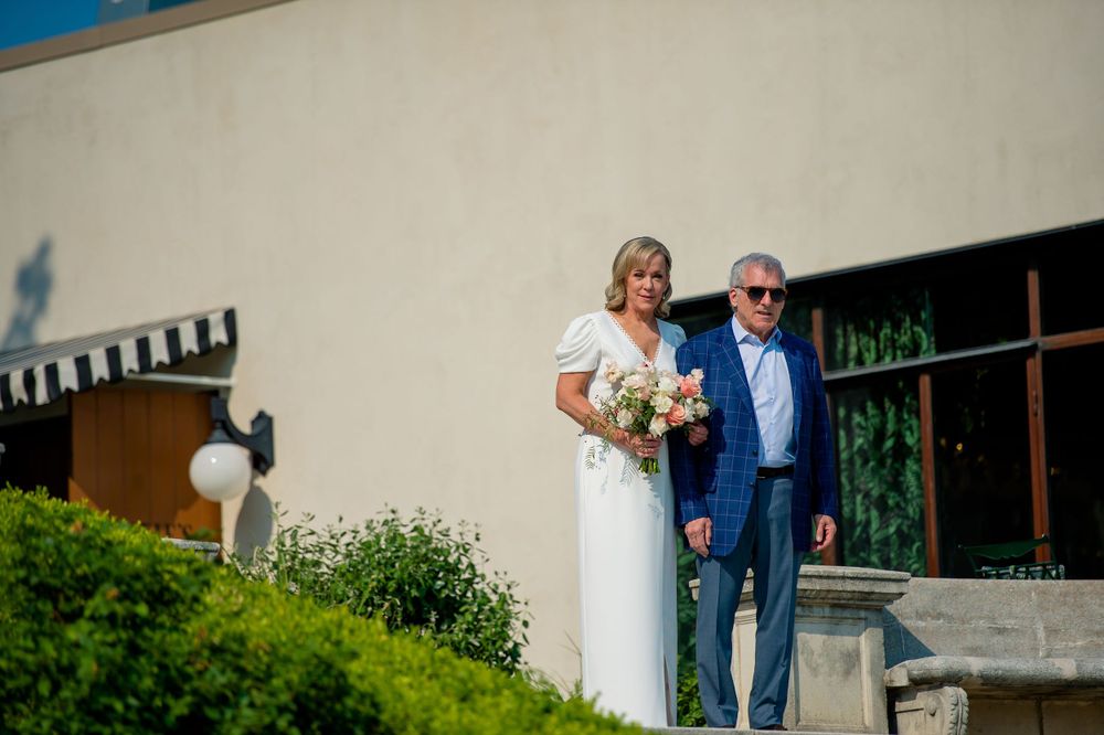 Couple poses together on garden steps during an outdoor wedding ceremony.Commodore Perry Estate Wedding